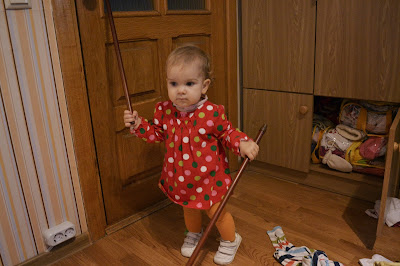 small girl playing with stick like a drummer girl