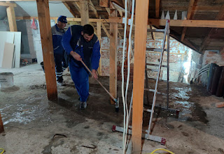 Cleaning up the floor ready for brick laying