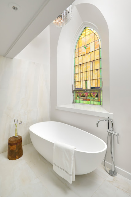 Stained glass window in modern bathroom Church conversion to chic private home Chicago