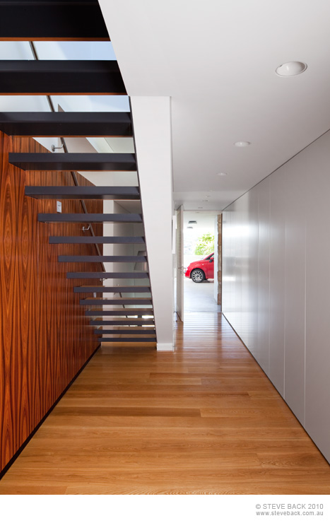 Hallway with staircase in the River House by MCK Architects
