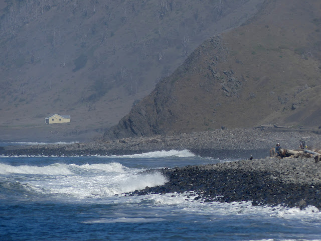 hikers on a rocky beach