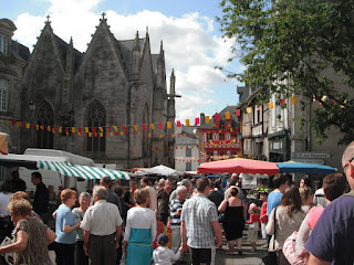 Bustling trade with lots of customers at the typical Brittany market