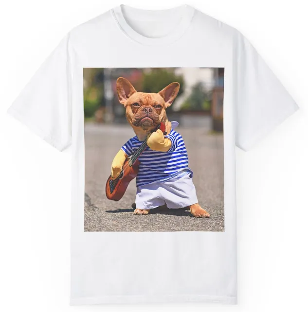 Unisex Garment Dyed Comfort Colors T-Shirt With French Bulldog Dressed Up with Street Performer Musician Costume Wearing Striped Shirt and Fake Arms Holding a Toy Guitar Standing in City Street on Sunny Day