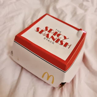 A white square box with the spicy Spanish stack in red font on a bright background