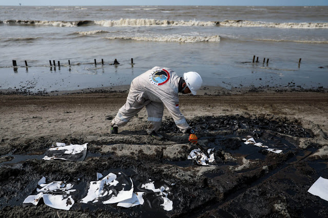 On August 4, 2019, a worker collects sand contaminated by an oil spill at a shoreline in Karawang, West Java, Indonesia. via Andrew Gal/NurPhoto