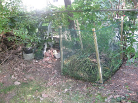 simple compost bin, pile, wood posts, fence