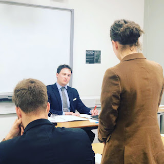 A photo of Elijah Granet listening to submissions during the moot.