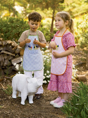 children wearing art aprons