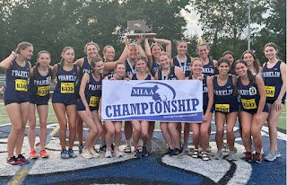 The Franklin girls' track team poses with the Division 1 state trophy after taking the program's first title Sunday at Westfield State. MATTY WASSERMAN FOR THE GLOBE