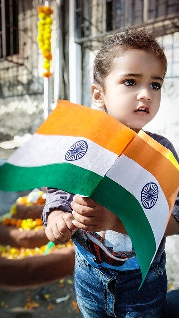 A cute Baby holding Indian Flag