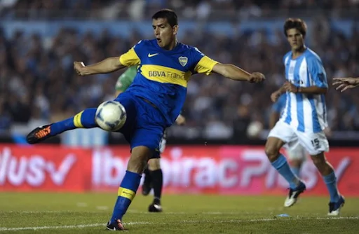 Boca Juniors player Lucas Viatri kicks the ball to score against Racing Club