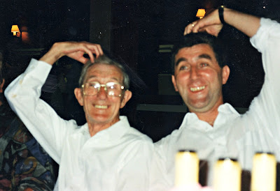 Two men messing about in a pub in the 80s