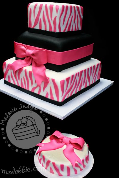 The top and bottom tiers were decorated with pink fondant zebra print 