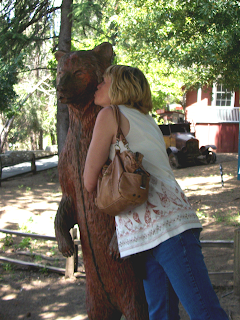 Cindy kissing wooden bear