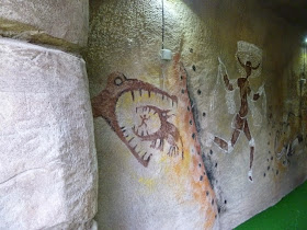 Some ancient alligators on a cave painting at the Jungle Island Adventure Golf course at Horton Park Golf Club in Epsom, Surrey