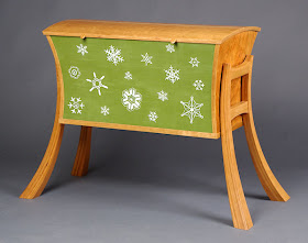 blanket chest, partially painted green with snowflakes