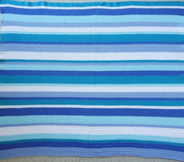 Looking for inspiration and ideas for a cute and easy stripy crochet blanket?  This is made in calm blue and green stripes, for a restful ocean feel.  Click to find out more details on the yarn and pattern used!