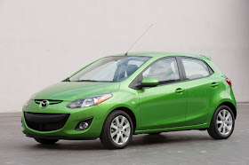 Front 3/4 view of green 2011 Mazda 2