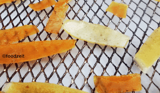 Orange and lemon peel drying on the mesh