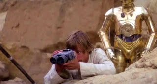 A screen shot from Star Wars showing Luke with his Binoculars