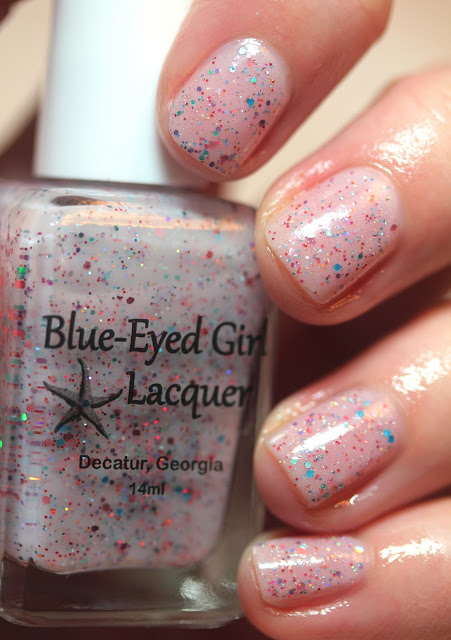 pink nail polish with blue and orange glitter