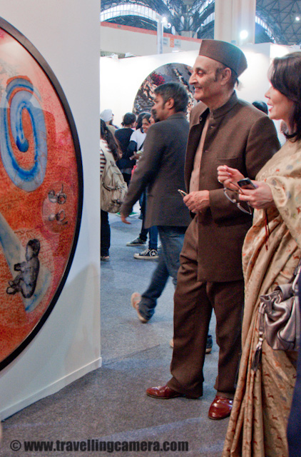 India Art Summit 2011 - A good place to find out world's best Art pieces at one place - A three days event @ Pragati Maidan, Delhi, INDIA : Posted by VJ SHARMA on www.travellingcamera.com : Recently INDIA ART SUMMIT happened in Delhi at Pragati Maidaan - 21st to 23rd Jan 2011 !!! It was first time I planned to visit it with some of my friends... Here are few photograph from INDIA ART SUMMIT 2011 !!! Check Out these photographs of various art forms without any details about artists who created them. Sorry to all artists because I tend to forget names...Here is the first artwork we saw just in front of entry gate... It was cycle-Rikshaw loaded with lot of metal pots on it... No one was around who had camera and we were not very comfortable while clicked few shots of this art... These pots had amazing reflection of the whole area in surroundings but we couldn't give much to time to capture it better...A close-up but not very clean... @ INDIA ART SUMMIT 2011This one was my favorite ART there... Guess what it is? If you guess it correctly that means my photograph is bad ! There were approximately 10 people standing around this table and wondering why these old newpapers are showcased here? Everyone was at the distance of 2-3 feets from this table and none was allowed to touch any of the art works... Then one of the lady asked the artist to give some information about this particular art and everyone was like WOW, how it can be a artwork of marble stone... But yes it was made up of marble stone with some printing with specific powder.... Lovely Work !!!Check out if you can notice something in this capsule pack... If not, it may be because of my blurry photograph :) Here is a wooden art @ INDIA ART SUMMIT 2011Another form o artwork which was created with threads and no machine was used in this... Apart from thread some metallic strings were also used.... This Photograph shows a very basic and small portion of a huge artwork hanging there...Mirror Art - A Mirror created of various particles in triangular shape... This mirror was created very neatly and had wonderful effects from various angles.. Most of the visitors were spending lot of time in front of these mirrors at INDIA ART SUMMIT 2011Another artwork which was rotating continuously and yes many of th artists were using some mechanical or electrical supports to add more value to their arts... and most of the support material was also designed by these artists in their own way ... Deepak experimenting of various colors of INDIA ART SUMMIT.. I think he was trying to play with depth of field to get some special effect out of the special artwork of colorful buttons and pins !!! There was gallery of arts which were created from pins and buttons of different colors.. Some of these arts had abstract shapes and few of them had some shapes which we could recognize...Gang having fun @ ART SUMMIT 2011.... Deepak looks unhappy with the results but Anchita wants to see what he clicked... Some amazing art work by Religare Art Gallery, CP, Delhi !!!Some famous personalities were roaming around to find out the best art for their houses....There were lot of foreigner Artists @ INDIA ART SUMMIT 2011He is about to stand up and have a walk at ART SUMMIT hall....Lot of Colors, Shapes and concepts @ INDIA ART SUMMIT, 2011