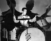 Famous photo of Gene Krupa at his drumset with a large shadow cast on the wall behind him