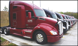 Lineup of Tribe Transportation Kenworth T680s