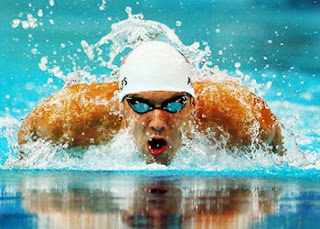 Image of a swimmer swimming hard wearing a swim cap