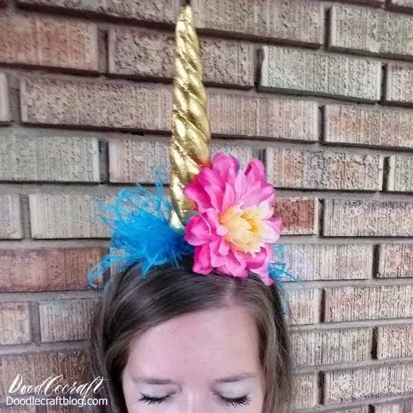 Me wearing a floracraft styrofoam unicorn horn headband made with treasure gold paint from Plaid, marabu feathers and silk flowers.  I am gorgeous and sleepy.