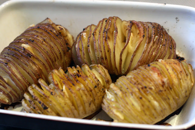 Close-up of 4 hasselback potatoes baked.