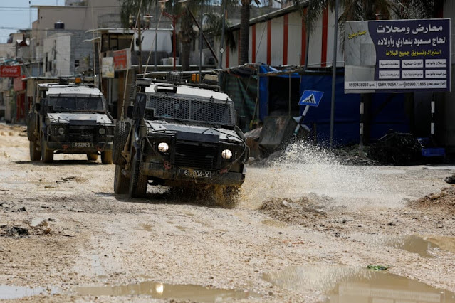 Israeli troops raid West Bank refugee camp, Gaza fighting continues