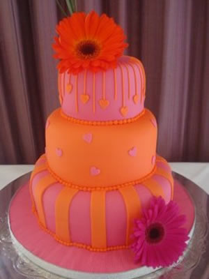 Orange and pink three tier wedding cake decorated with pink daisies original