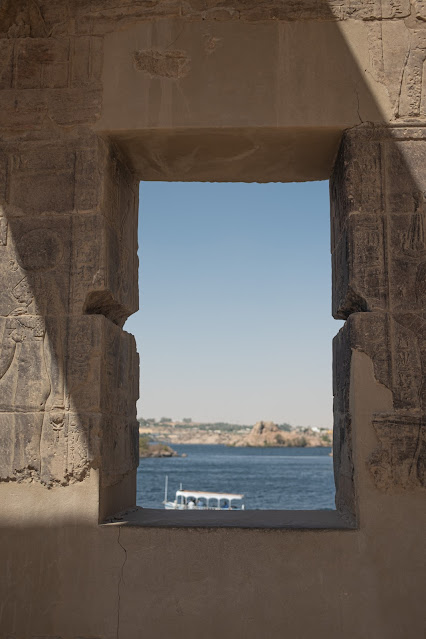 View of the Nile River through a window from inside Philae Temple