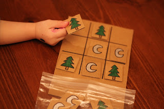 Child toddler playing DIY tick-tac-toe game reduce reuse recycle