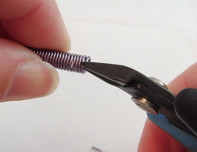 Cutting the jump rings from the coil using the flush cutters 