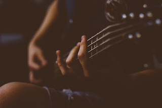 Canva - Person Playing Guitar