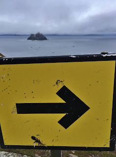 Caution sign on the the Skellig Michael staircase with Little Skellig Island in the background, Skellig Michael, County Kerry, Ireland