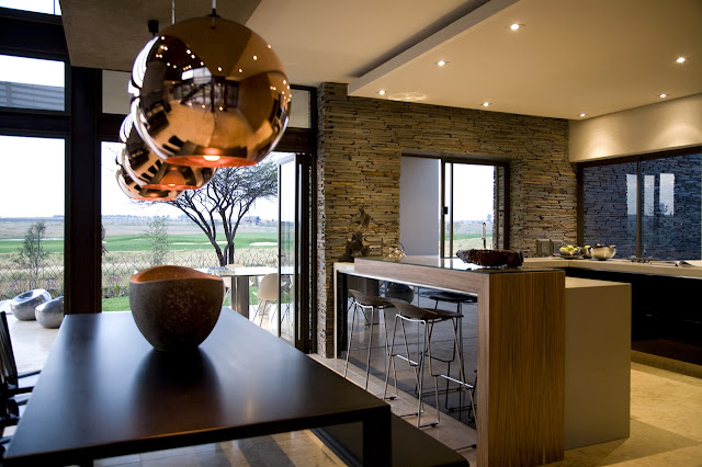 Modern kitchen and dining room of Serengeti House by Nico van der Meulen Architects 