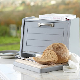 bread bin with space underneath for a bread board (shown with bread on it)