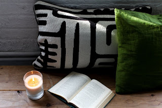 Candle, Pillow, and Books