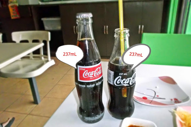 full height picture of two different sized Coke bottles labeled 237ml