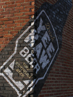 Painted logo on red brick for Yee Haw Brewing Co.