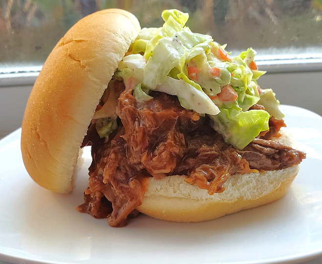 pork and cole slaw piled high in rolls