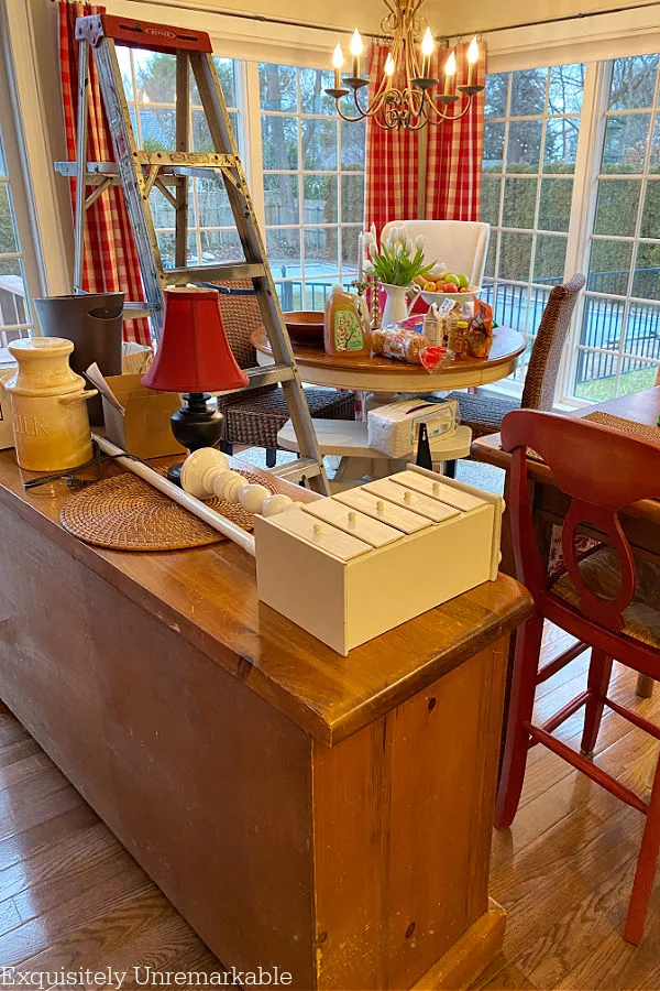 Kitchen furniture and accessories in middle of the room with ladder