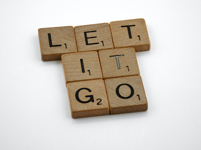 Scrabble tiles forming the words "Let It Go" (Credit: Brett Jordan/Unsplash)