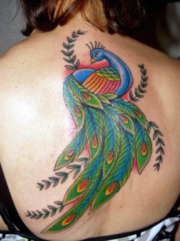 The back looks beautiful with this amazing peacock tattoo with leaf designs 
