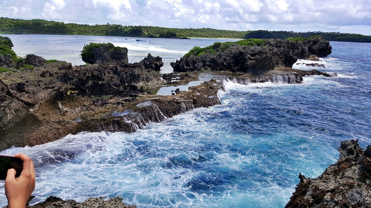 craggy cliffs being battered by giant pacific waves at Canhugas Nature Park in Hernani Eastern Samar