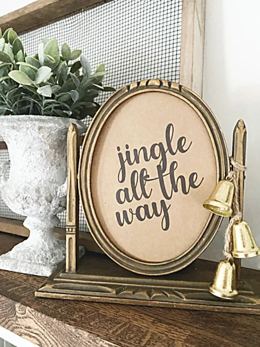 Jingle sign on mantel with bells