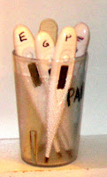 cup of many individual thermometers, with each family member's initial